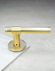 CHISEL door handle in Brushed Brass. Classic door hardware made of solid brass by BRANDT Collective.