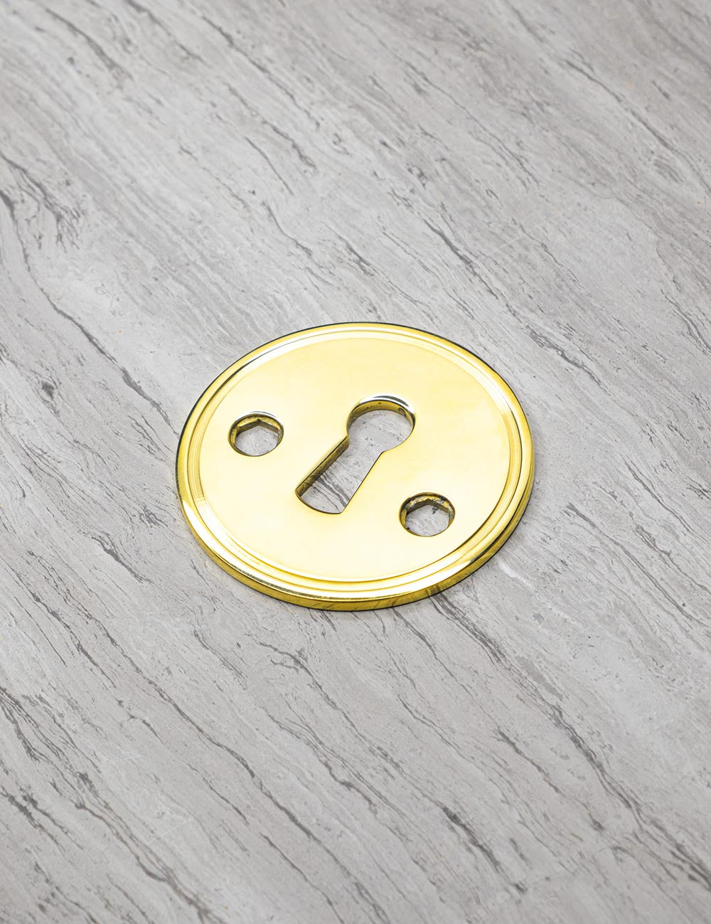 CHISEL keyhole in Polished Brass. Luxury door hardware by BRANDT Collective.