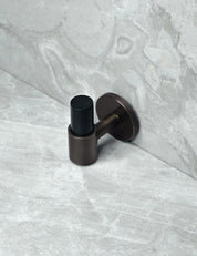 SIGNATURE 30 END knob in Burnished Brass/Black Horn. Luxury cabinet hardware made of solid brass by BRANDT Collective.