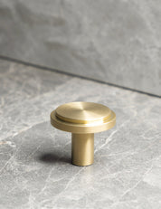 EDGE Knob in Brushed Brass. Elegant cabinet hardware designed by BRANDT Collective.