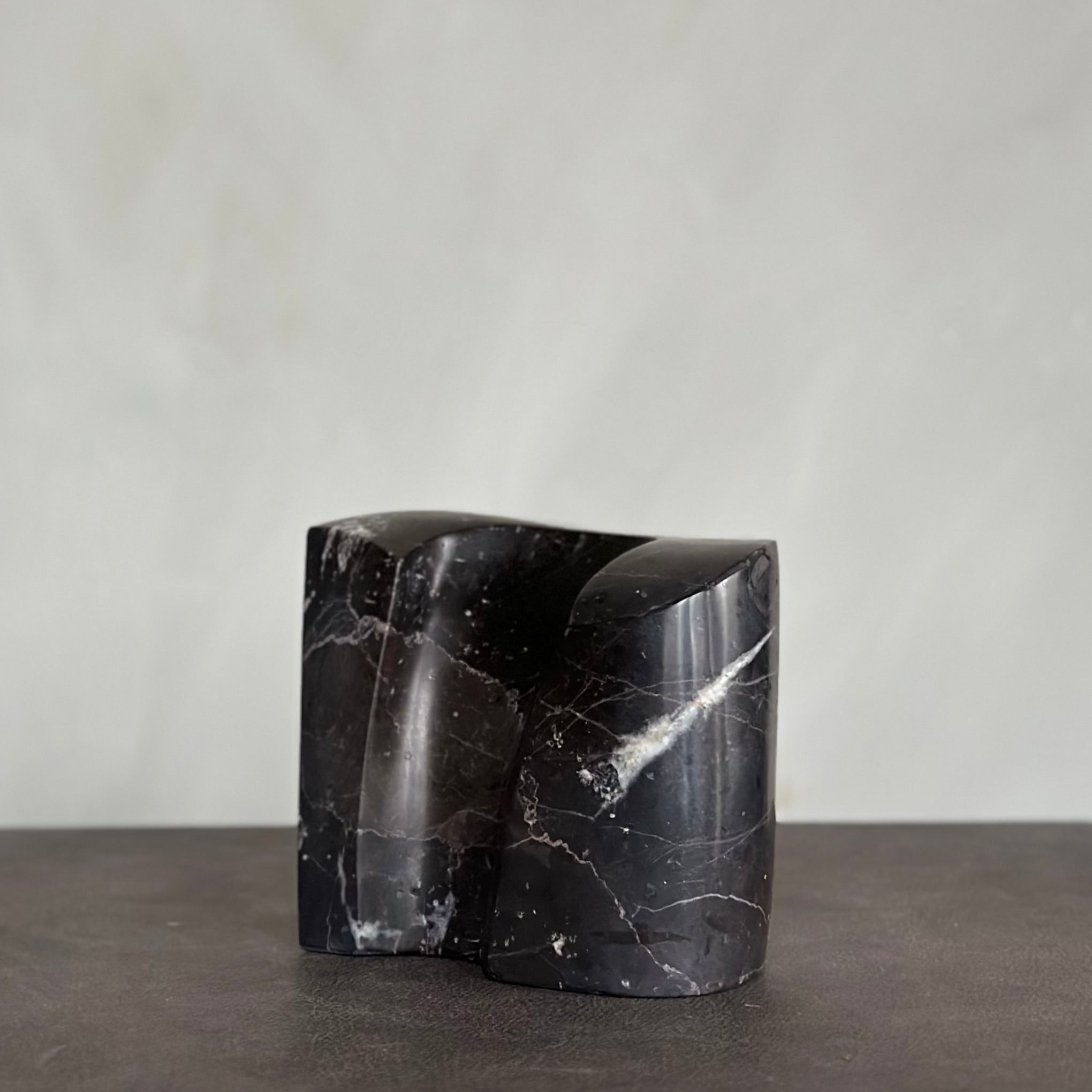 EMBRACE sculpture in SHADOW BLACK marble is designed by Julie Brandt for BRANDT Collective.