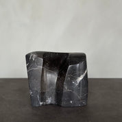 EMBRACE sculpture in SHADOW BLACK marble is designed by Julie Brandt for BRANDT Collective.