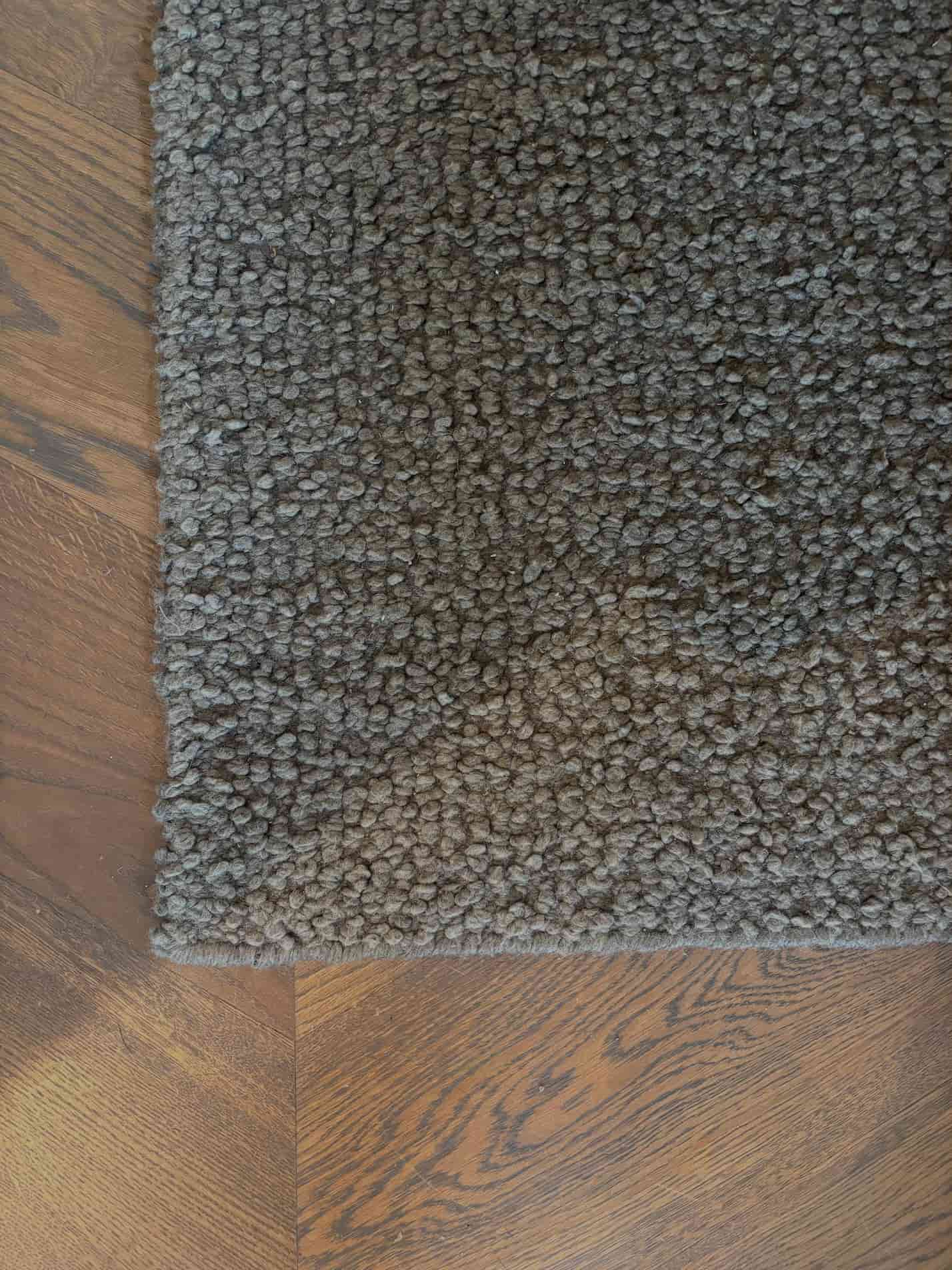 Handcrafted/woven wool bucle carpet in a greenish grey color