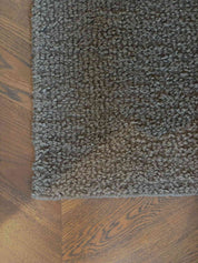 Handcrafted/woven wool bucle carpet in a greenish grey color