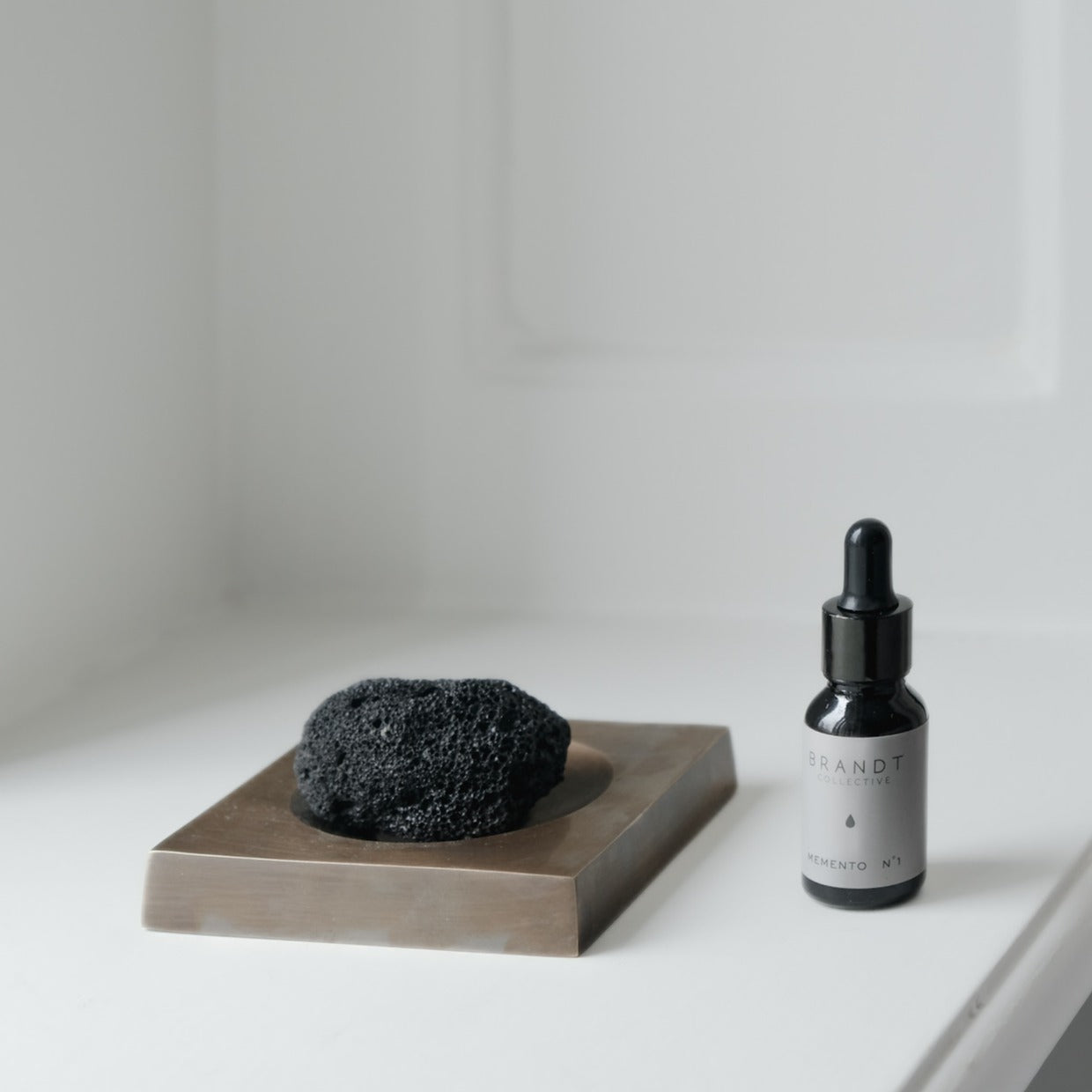 PLATEAU fragrance tray set in Burnished Brass, lava rock and oil. Designed by Julie Brandt for BRANDT Collective