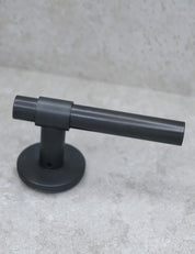 SIGNATURE door handle in nearly black and nearly black. Modern door hardware made of solid brass by BRANDT Collective.