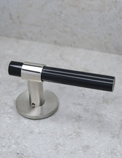 SIGNATURE door handle in Brushed Nickel/Black Horn. Modern door hardware made of solid brass by BRANDT Collective.