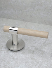 SIGNATURE door handle in Polished Nickel/Oak. Modern door hardware made of solid brass by BRANDT Collective.