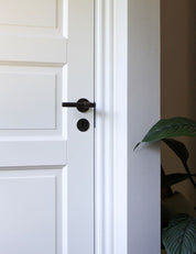 SIGNATURE door handle in Burnished Brass/Wenge. Modern door hardware made of solid brass by BRANDT Collective.