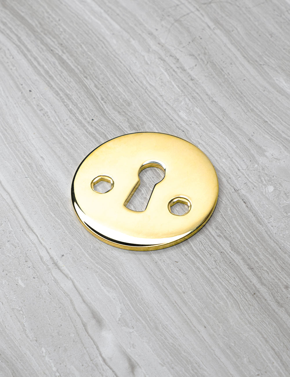 SIGNATURE keyhole in Polished Brass. Luxury door hardware by BRANDT Collective.