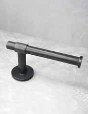 SIGNATURE toilet roll holder in Nearly Black. Luxury bathroom hardware made of solid brass  by BRANDT Collective.