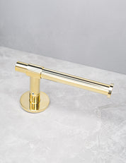 SIGNATURE toilet roll holder in Polished Brass. Luxury bathroom hardware made of solid brass by BRANDT Collective.