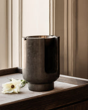 AURA Oil Burner diffuser from BRANDT Copenhagen with a marble base in Riyal Grey and metal top in satin brass