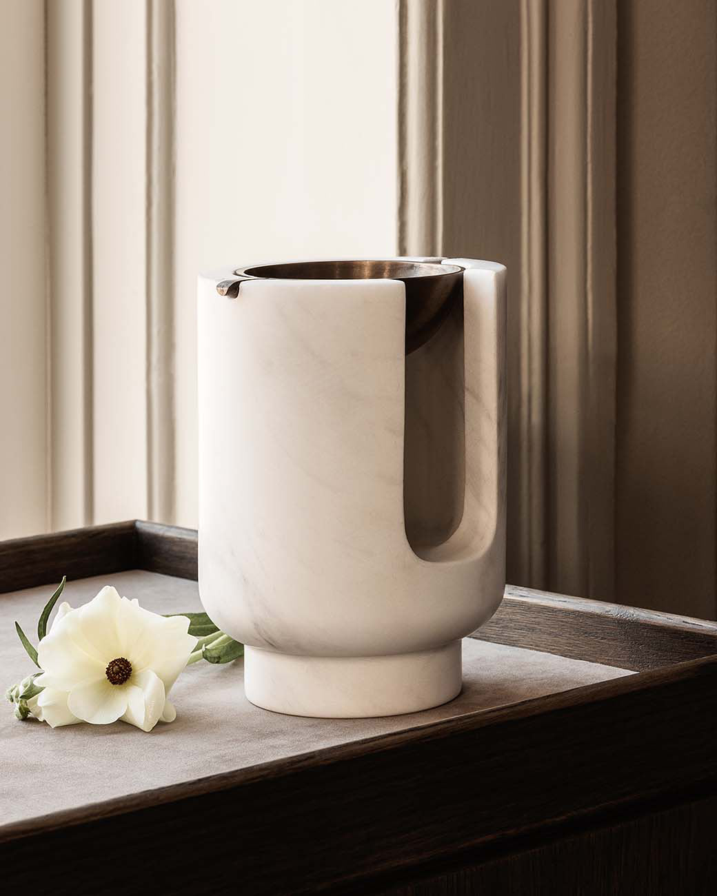 AURA oil burner in Snow White marble and bowl in burnished brass patina. Designed by Julie Brandt for BRANDT Copenhagen.
