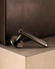BUTTON door handle set in Gunmetal by BRANDT Copenhagen. Designed in collab with Norm Architects.