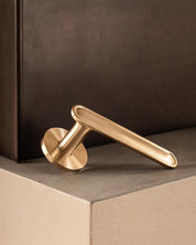 BUTTON door handle in Satin brass by BRANDT Copenhagen. Designed in collab with Norm Architects.