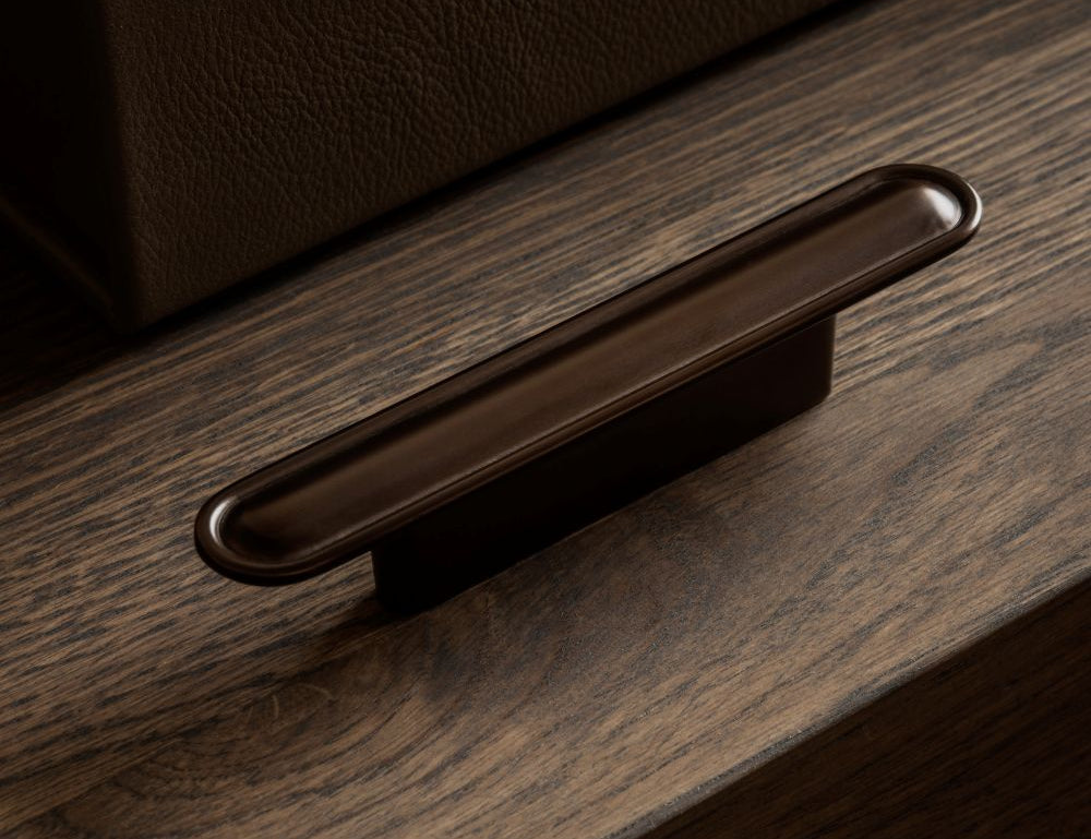 BUTTON pull bar 110 mm in burnished brass by BRANDT Copenhagen. A hardware collection in collab with Norm architects consisting of knobs, T-bars and pull bars for kitchens and cabinets.