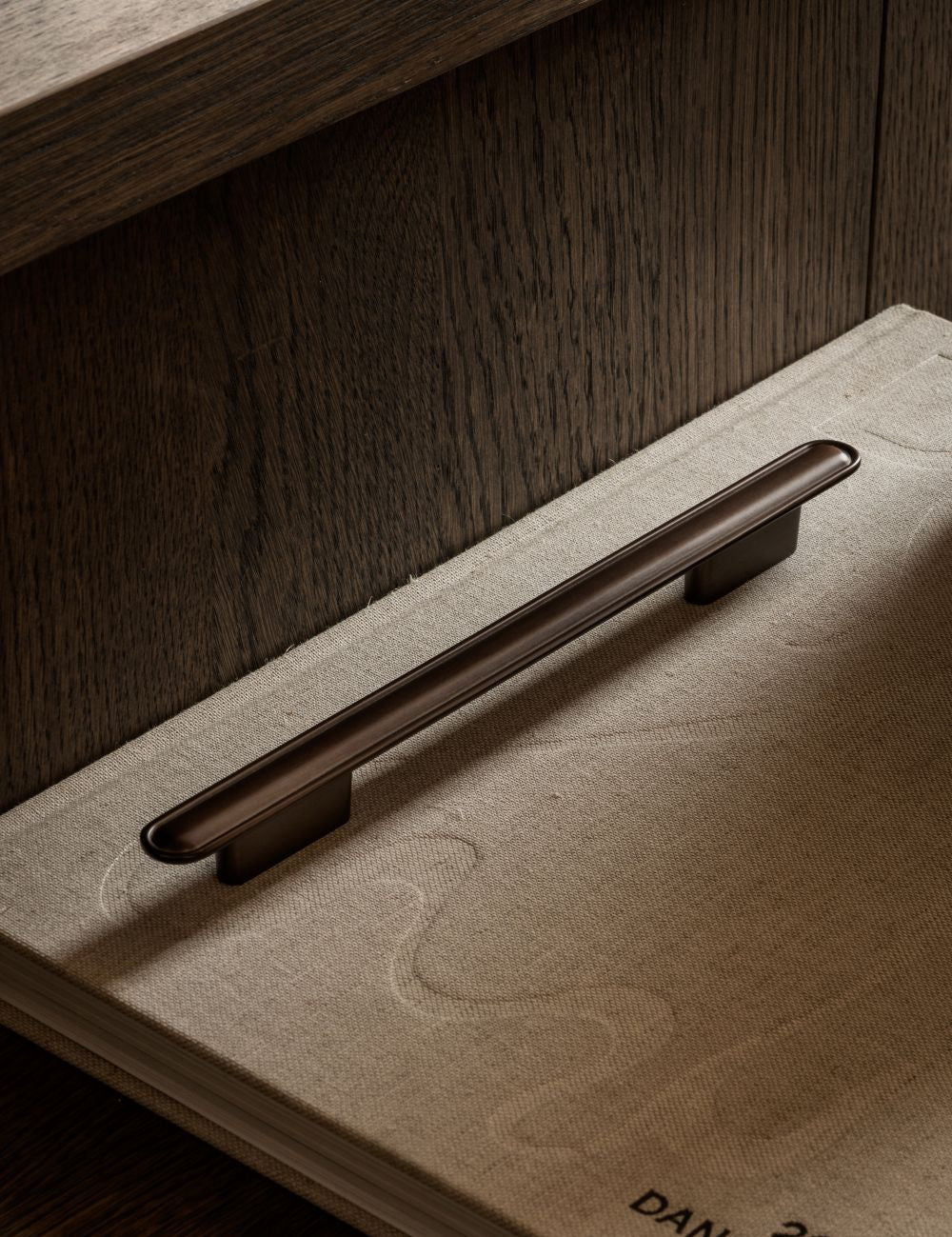 BUTTON pull bar 250 mm in burnished brass by BRANDT Copenhagen. A hardware collection in collab with Norm architects consisting of knobs, T-bars and pull bars for kitchens and cabinets.