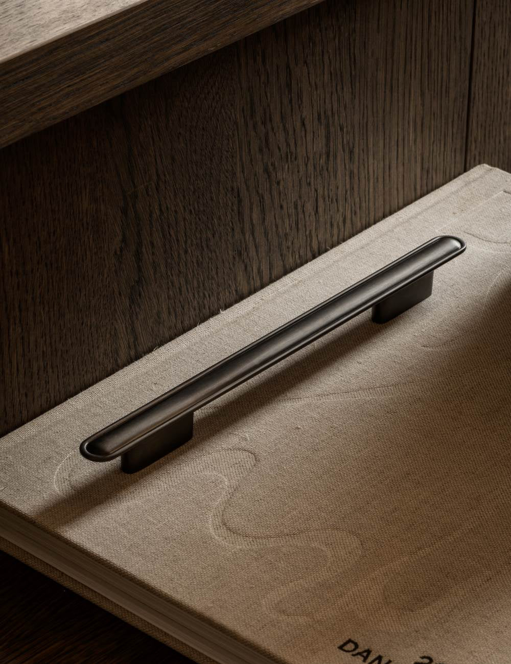 BUTTON pull bar 250 mm gunmetal by BRANDT Copenhagen. A hardware collection in collab with Norm architects consisting of knobs, T-bars and pull bars for kitchens and cabinets.