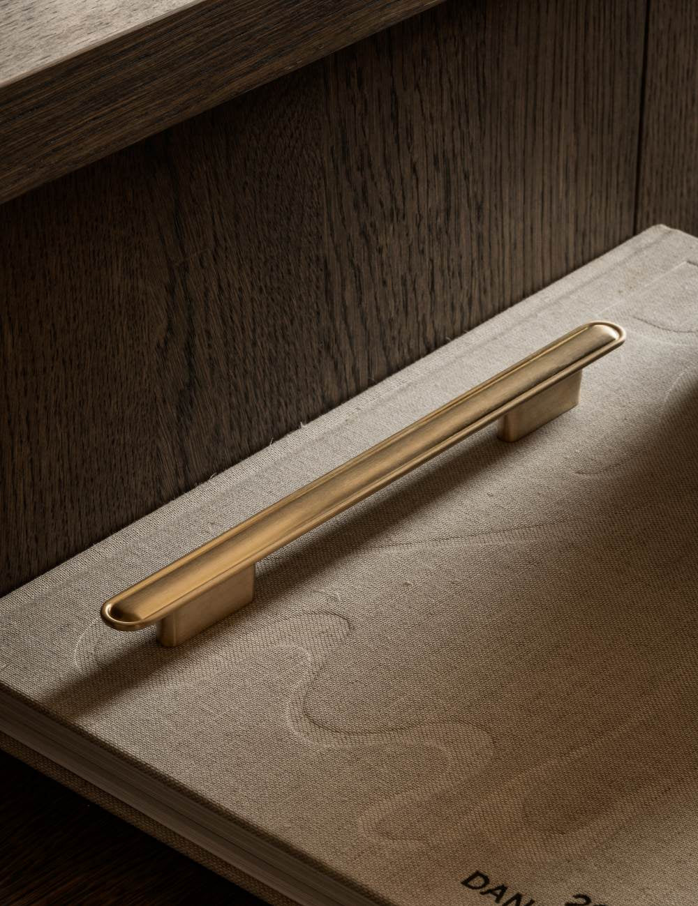 BUTTON pull bar 250 mm satin brass by BRANDT Copenhagen. A hardware collection in collab with Norm architects consisting of knobs, T-bars and pull bars for kitchens and cabinets.