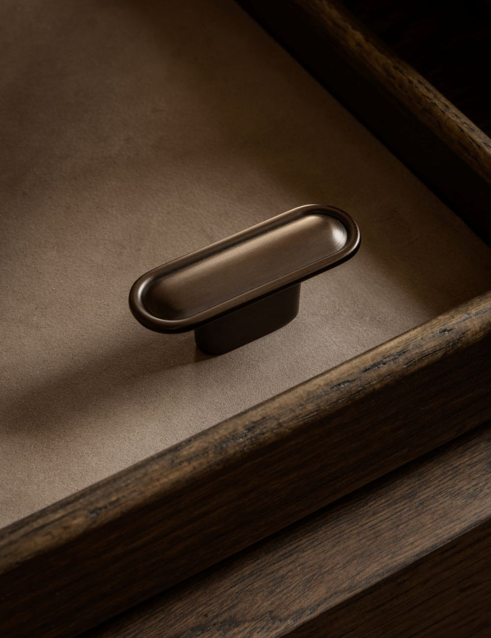 BUTTON T-bar in burnished brass by BRANDT Copenhagen. A hardware collection in collab with Norm architects consisting of knobs, T-bars and pull bars for kitchens and cabinets.