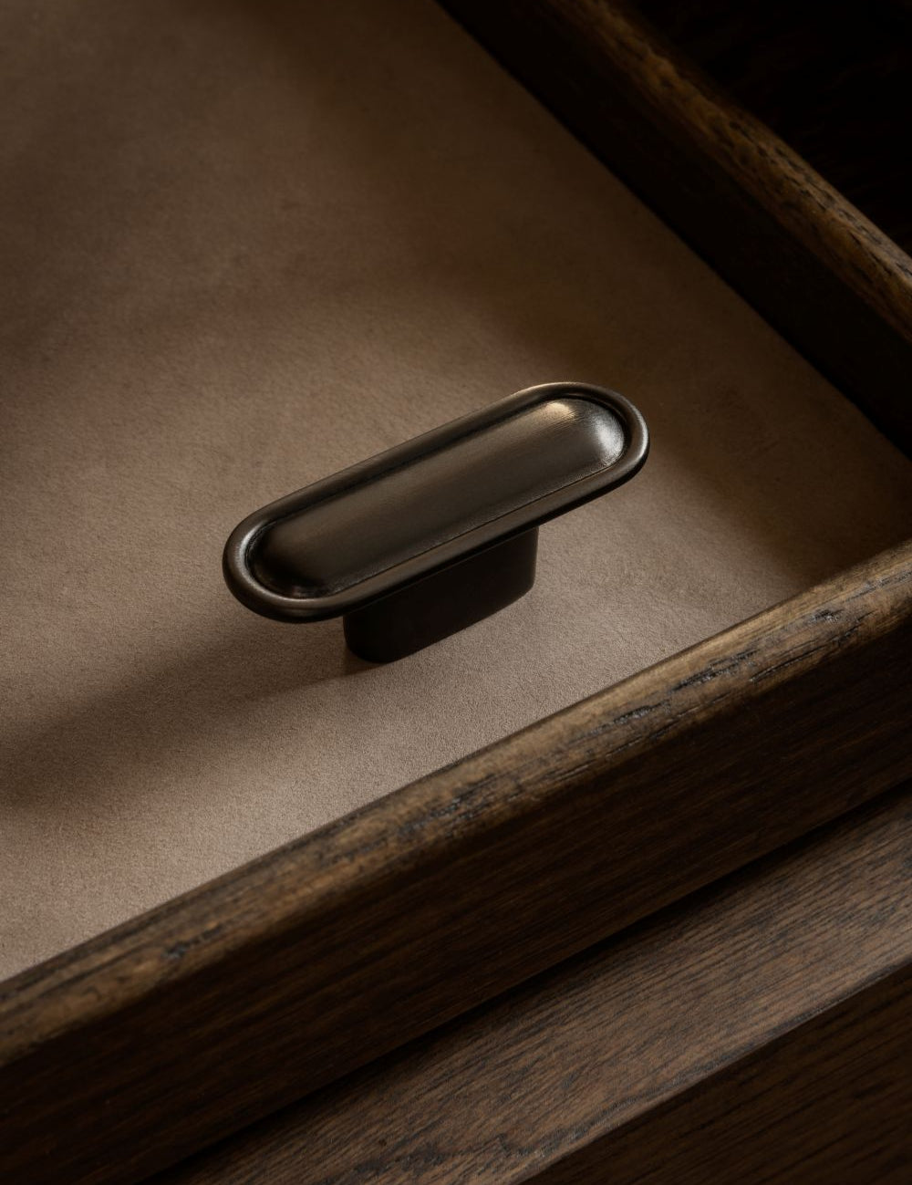 BUTTON T-bar in gunmetal by BRANDT Copenhagen. A hardware collection in collab with Norm architects consisting of knobs, T-bars and pull bars for kitchens and cabinets.