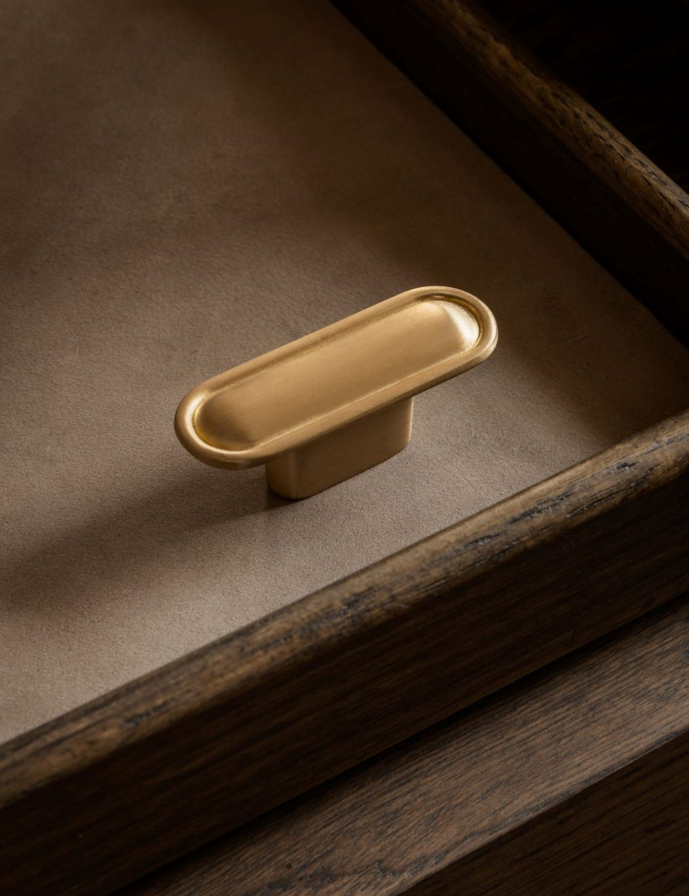 BUTTON T-bar in satin brass by BRANDT Copenhagen. A hardware collection in collab with Norm architects consisting of knobs, T-bars and pull bars for kitchens and cabinets.