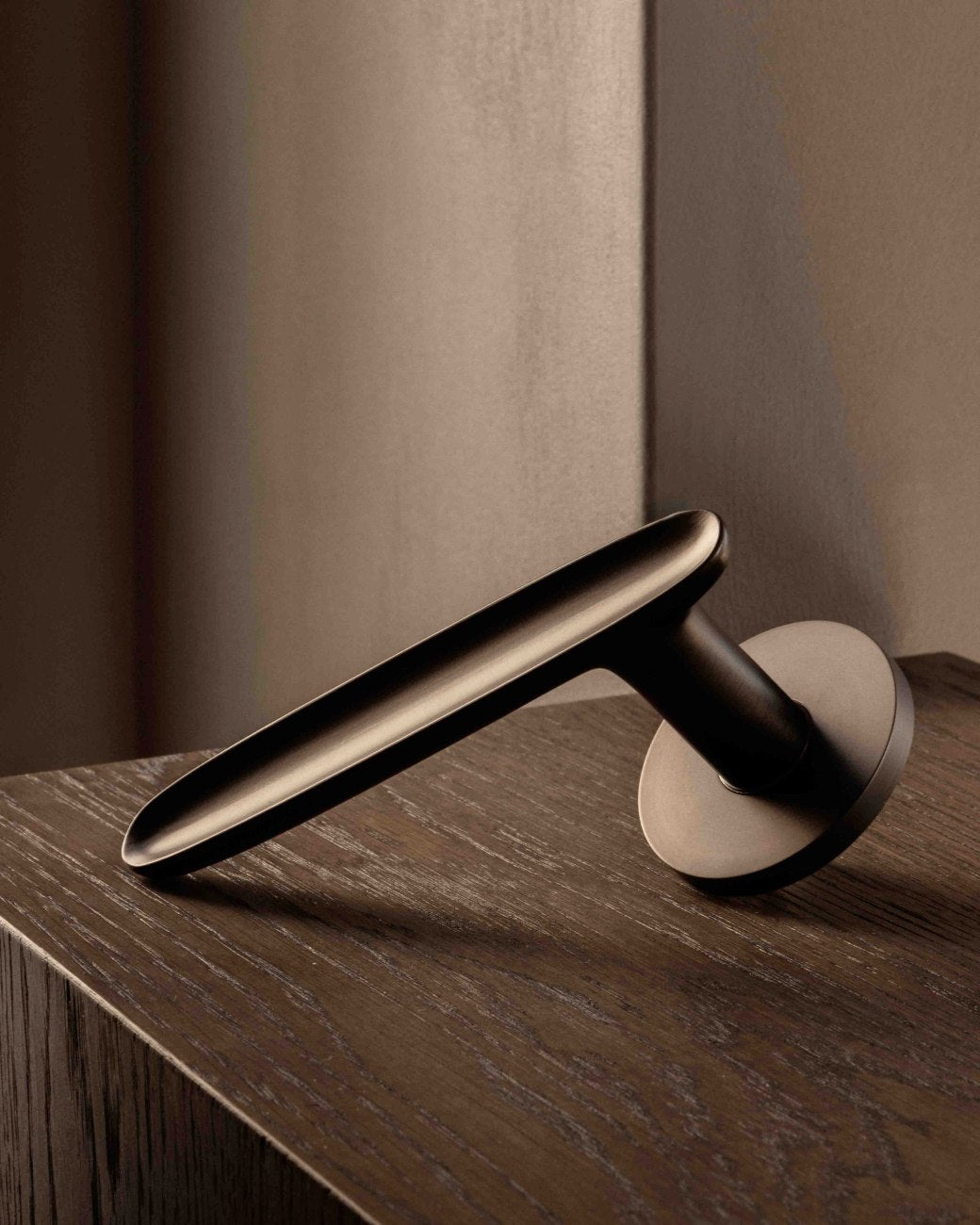 LEAF door lever handle sprung in burnished brass by BRANDT Copenhagen. Designed oin collab with Norm architects.