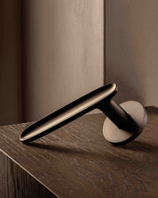 LEAF door lever handle sprung in burnished brass by BRANDT Copenhagen. Designed oin collab with Norm architects.