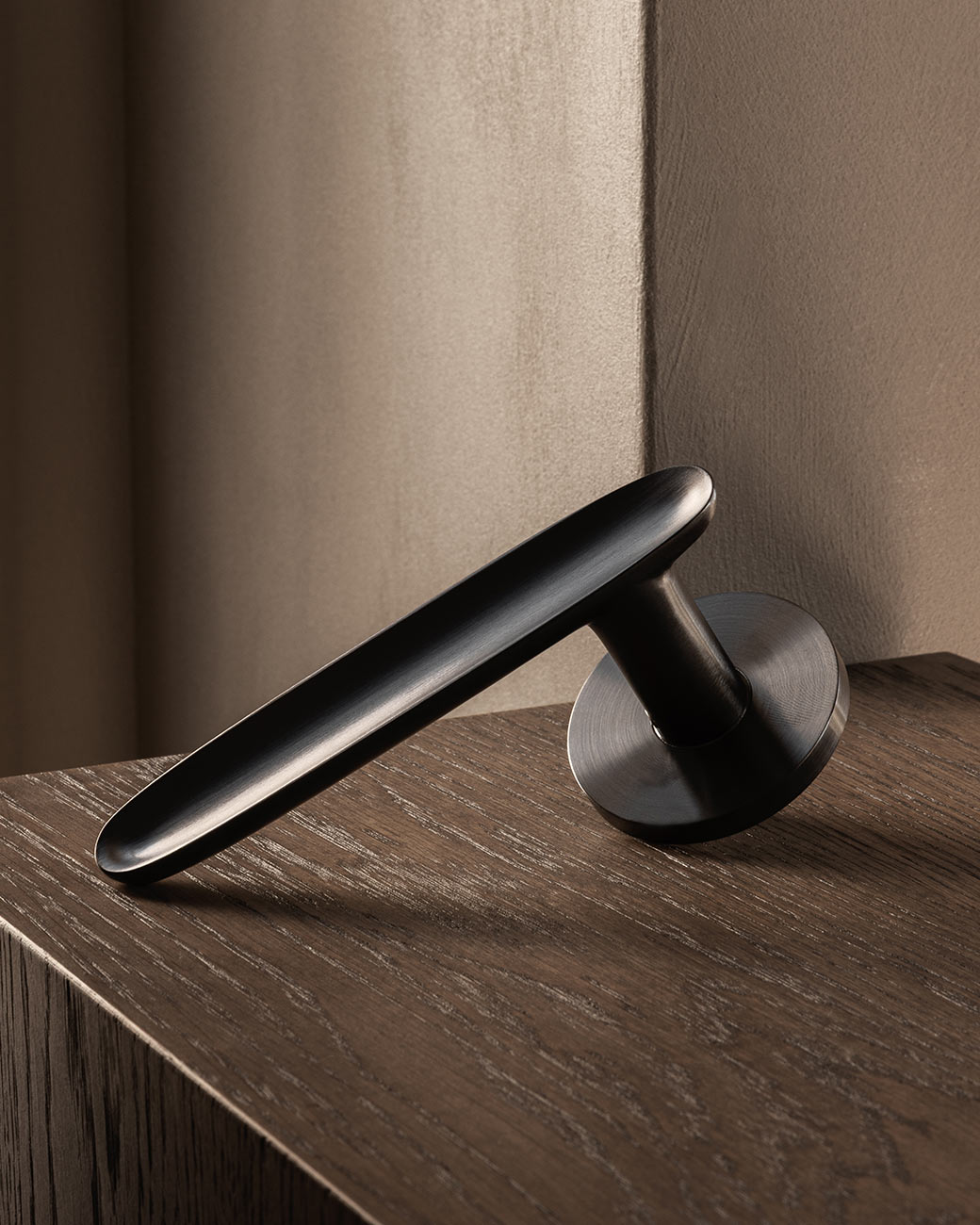 LEAF door lever handle in Gunmetal Sprung version by BRANDT Copenhagen. Designed in collab with Norm Architects.