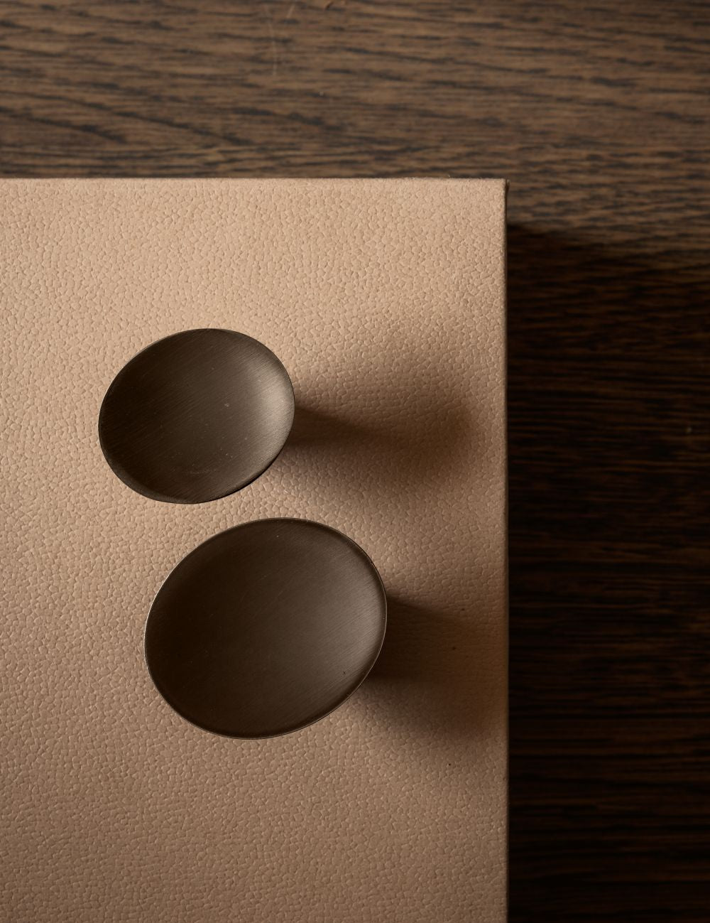 leaf hook round for wall mounting in burnished brass shown together with the knob small. Designed by Norm architects for brandt copenhagen