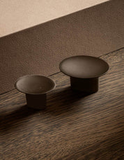 leaf hook round for wall mounting in burnished brass shown together with the knob small. Designed by Norm architects for brandt copenhagen