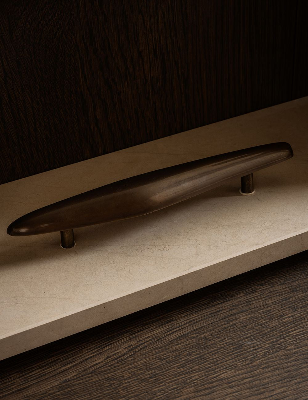 NOBLE pull bar long in Burnished Brass Patina made of solid brass and organically shaped. Designed by Julie Brandt for BRANDT Copenhagen. 