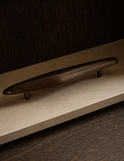 NOBLE pull bar long in Burnished Brass Patina made of solid brass and organically shaped. Designed by Julie Brandt for BRANDT Copenhagen. 