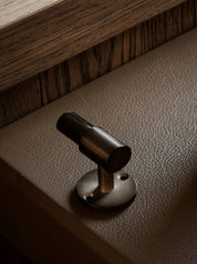 SIGNATURE hook for tea towels or bathroom towels made of solid brass with finish in Burnished Brass and Black Horn. Designed by Julie Brandt for BRANDT Copenhagen.