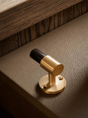 SIGNATURE hook for tea towels or bathroom towels made of solid brass with finish in Satin Brass and Black Horn. Designed by Julie Brandt for BRANDT Copenhagen.