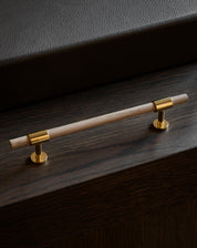 SIGNATURE slim pull bar 182 mm in Polished Brass / Oak. Modern luxury cabinet handles made of solid brass by BRANDT Copenhagen.