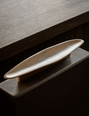 VALE pull bar long in Burnished Brass Patina is made of solid brass. VALE is part of our organic shaped hardware collection with handles for kitchen and cabinet front. Designed by Julie Brandt for BRANDT Copenhagen. 